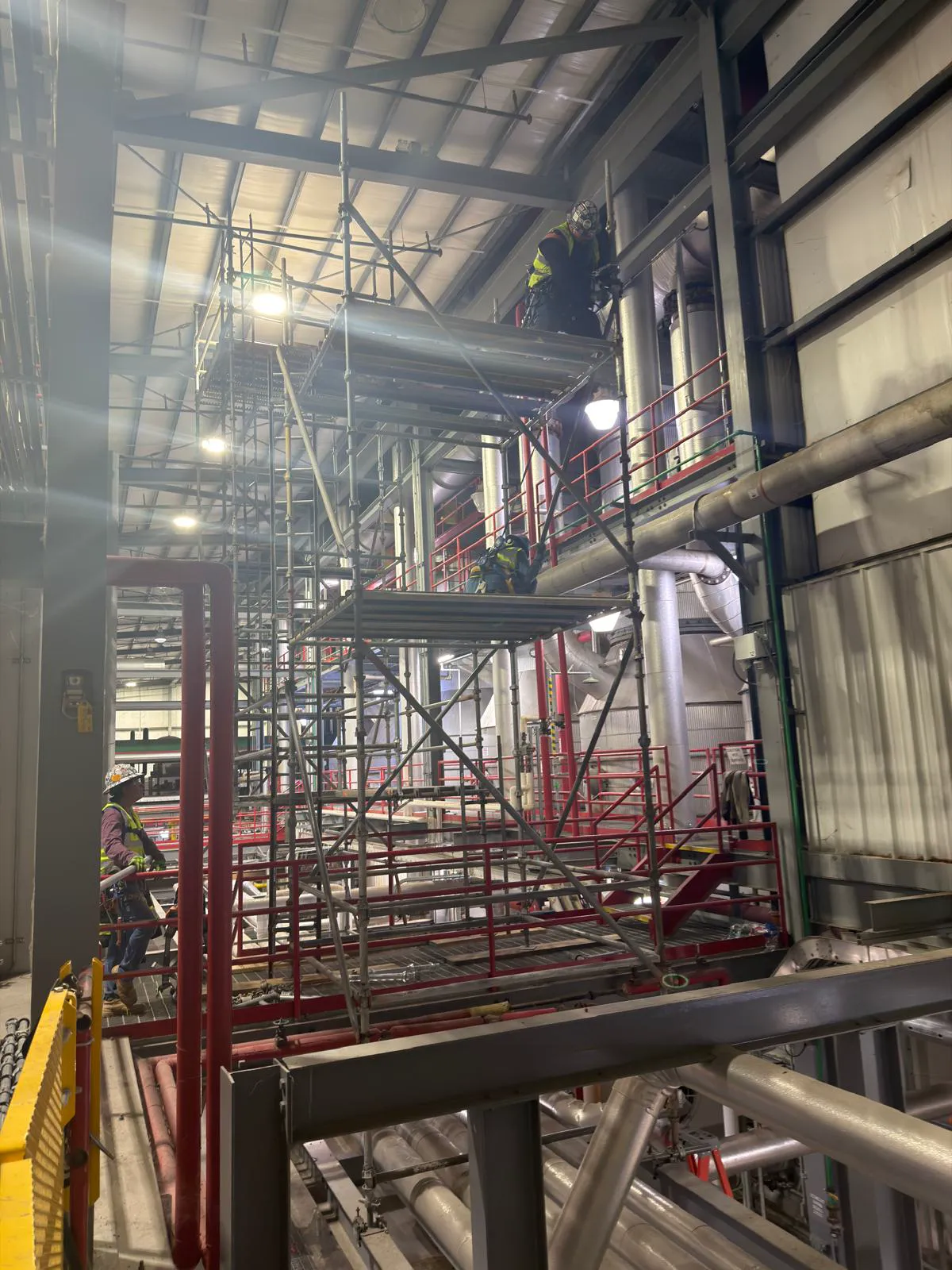 Crew working multi-level scaffolding in plant
