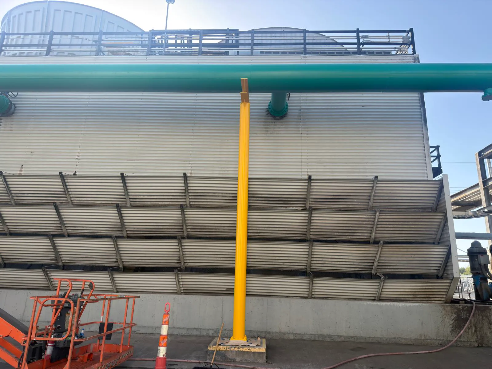 Freshly coated green piping on cooling tower