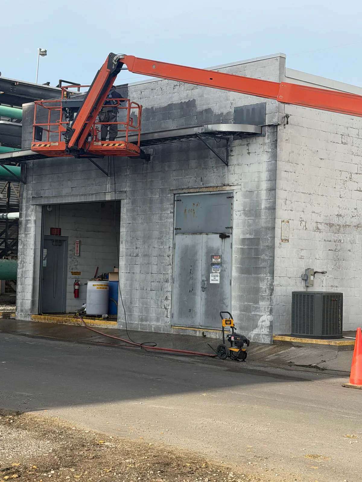 Pressure-washing a concrete block building